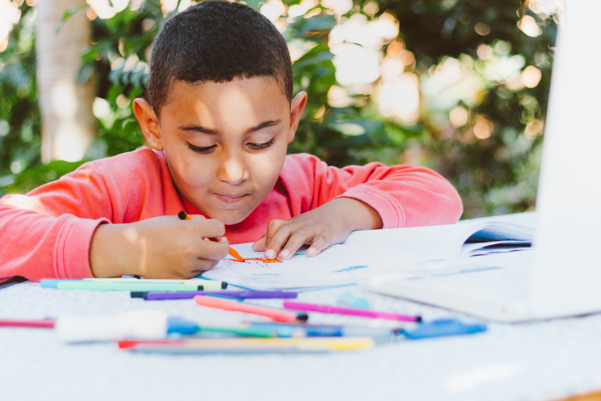 Young male student coloring.
