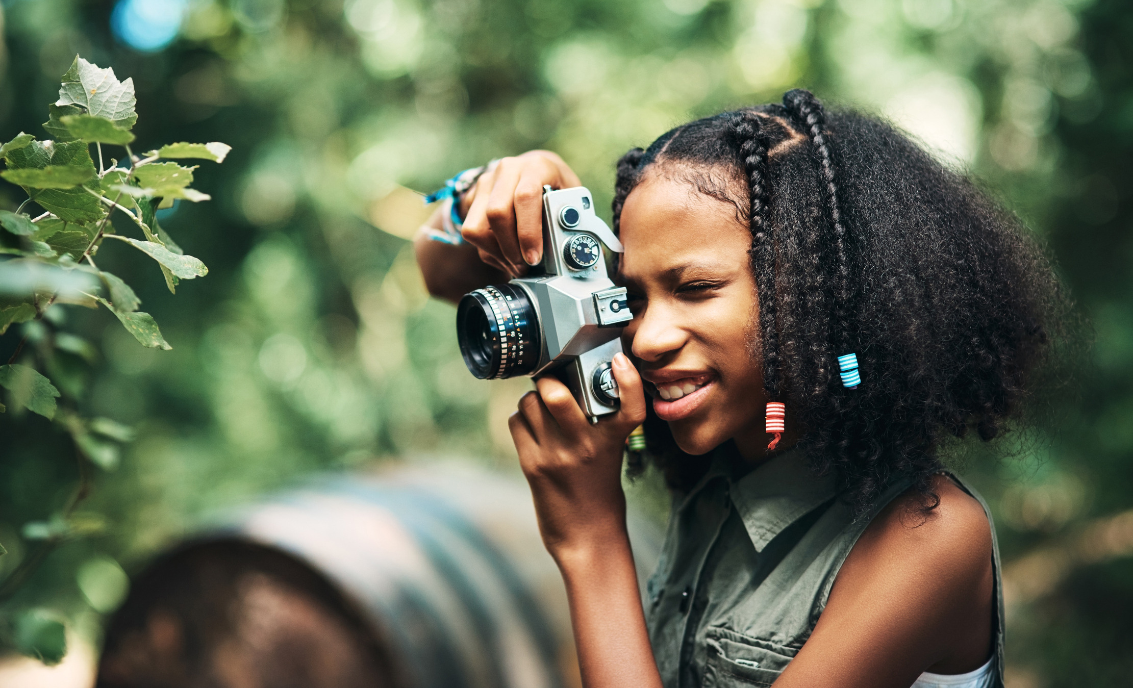 Young girl practicing photography as she explores her interests over the summer with Laurel Springs